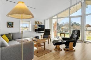 a living room with a couch and a table at LF10229-Thyholm-Skovstjernevej-9 in Thyholm
