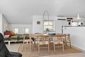 a dining room with a table and chairs at LF10229-Thyholm-Skovstjernevej-9 in Thyholm