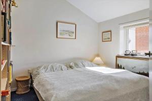 a bedroom with a bed and a window at LF10229-Thyholm-Skovstjernevej-9 in Thyholm