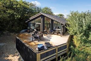 een huis met een houten terras met een tafel en stoelen bij LF11106-Struer-Slugten-6 in Humlum