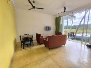 a living room with a table and chairs and a dining room at Oasi house in Unawatuna