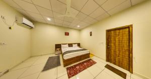 a bedroom with a bed in a room at Tejas Gir Villas in Sasan Gir
