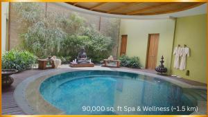 a swimming pool in the middle of a yard at The Mayfair Suites by AURACHE in Greater Noida