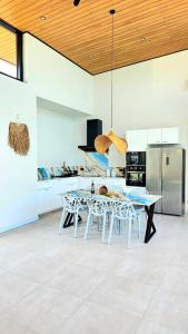 a kitchen with a table and chairs in a room at Villa Mona in Nathon Bay