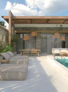 a patio with beds and a swimming pool at Casa Euphoria in Elounda