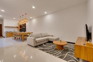 a living room with a couch and a table at Bhatara Villa Sanur in Sanur