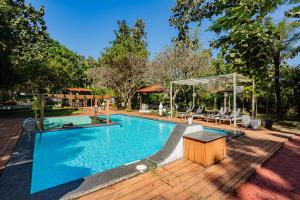 einen Pool auf einer Holzterrasse neben in der Unterkunft Kenwood's Farmstay - 6bhk with private pool in Zadapoli