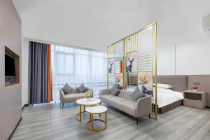 a hotel room with a bed and a couch at Good East Hotel in Guangzhou