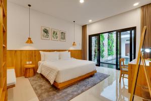 a bedroom with a bed and a table and a desk at Bhatara Villa Sanur in Sanur +66 photos