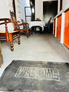 a welcome mat on the floor of a room with a table at Azure Coast Villa in Ahangama