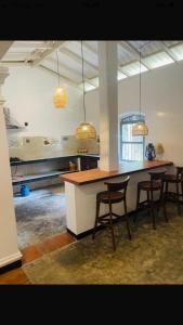 a kitchen with a table and chairs in a room at Calm Villa in Mihiripenne