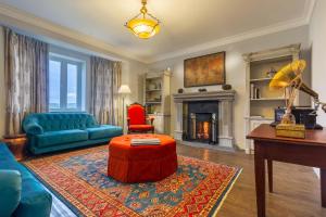 a living room with a couch and a fireplace at Kent Cottage in Nuwara Eliya