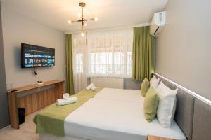 En eller flere senge i et værelse på Къща за гости Оскови