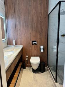 a bathroom with a toilet and a sink and a shower at Afrosiyob Regency Hotel in Stantsiya Kyzyl-Tukumachi