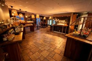 a large room with a bar and a restaurant at Hotell Siesta in Karlskrona