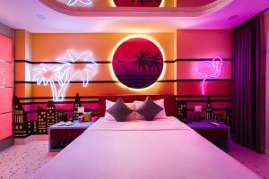 a bedroom with a large bed with pink lighting at Cupid Hotel 3 in Ho Chi Minh City +37 photos