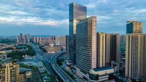 a city skyline with tall buildings and a highway at Mercure Chengdu Dongjiao Memory in Chengdu