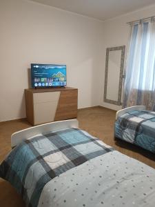 En eller flere senge i et værelse på Casa Deliver