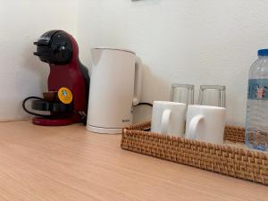a coffee maker and cups on a counter at Pinky Bungalows Resort & Villa in Ko Lanta