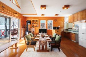 a kitchen with a table and chairs in a room at Chalet GOROU in Hakuba