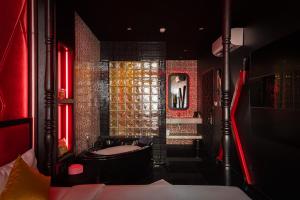 a bathroom with a tub and red lights in it at Cupid Hotel 3 in Ho Chi Minh City