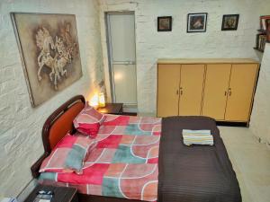 a bedroom with a bed and a couch in it at Ivory Room, AC, Smart TV, Ensuite, Independent Homestay in Mumbai