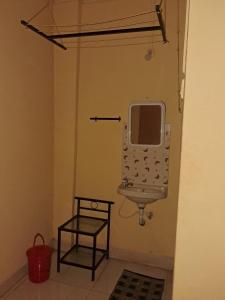 a bathroom with a sink and a mirror on the wall at Hotel Cosy Nook in Malvan