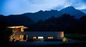 een gebouw met 's nachts bergen op de achtergrond bij Villa De View in Ban Tham