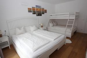 En eller flere senge i et værelse på Rosies Family Apartment Bad Kleinkirchheim