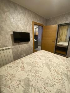 a bedroom with a bed and a flat screen tv at Pine Residence Zlatibor in Zlatibor