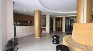 un soggiorno con divano e sedie nere di Honey Lodge a Pattaya Sud Altre 178 foto