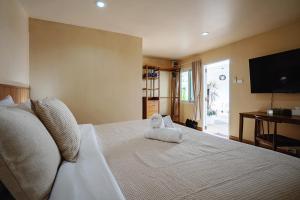a bedroom with a bed with two towels on it at Peridot Pool Beach in Chaweng Noi Beach +69 photos