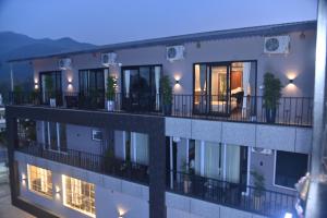 an apartment building with balconies and plants on it at Aarush Hotel & Resort in Haldwāni