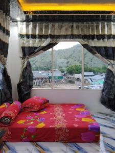 a bed in a room with a window at Komodo Village Tour & Homestay in Komodo