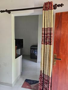a door with a curtain in a room at Pradeepa Villa in Weligama