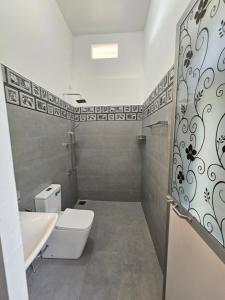 a bathroom with a toilet and a sink at Pradeepa Villa in Weligama