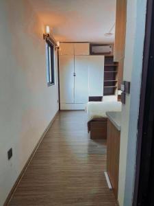 a small room with a kitchen and a refrigerator at Natural Light STU 402 Near Uncle Ho's Mausoleum in Hanoi