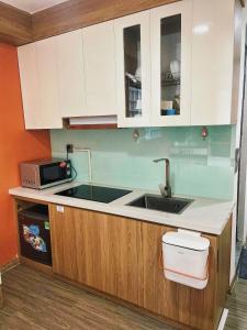a kitchen with a sink and a microwave at Natural Light STU 402 Near Uncle Ho's Mausoleum in Hanoi