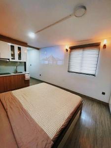 a bedroom with a large bed and a window at Natural Light STU 402 Near Uncle Ho's Mausoleum in Hanoi