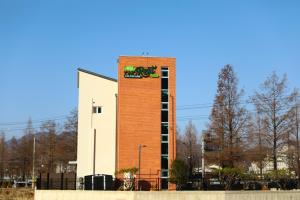 a building with a clock on the side of it at Two Rest Pension in Damyang