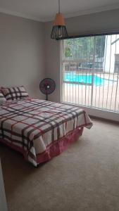 a bedroom with a bed and a swimming pool at Twin Power Guesthouse in Bloemfontein +40 photos