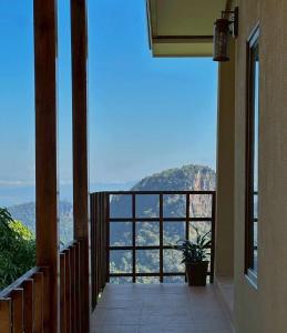 a balcony with a view of the mountains at Sayu Homestay&Cafe in Ban Pha Mi