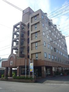 a large building on the corner of a street at Hotel Crown Hills Nakamura in Shimanto