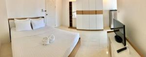 a bedroom with two beds with white shoes on it at Grandview Ladprao Hotel in Bangkok +11 photos
