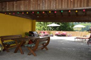 a patio with a wooden table and chairs and a picnic table at Casa Montana in Niedernsill