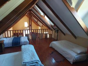 a attic room with two beds and a balcony at Tevreden in Rhodes