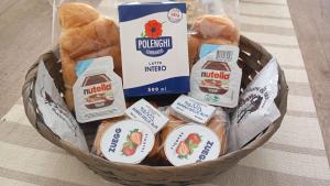 a basket filled with bread and other food items at Profumo di casa in Lascari