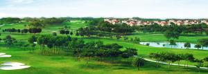 an overhead view of a golf course with trees and a lake at The Mayfair Suites by AURACHE in Greater Noida