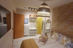 a bedroom with a bed and a large mirror at Apartamenticos Studio 98 in Zaragoza