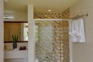 a bathroom with a shower with a glass door at Season Paradise in Thulusdhoo
